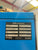 Blue ALMIG Kompressor with technical label on a blurred background