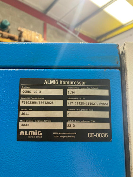 Blue ALMIG Kompressor with technical label on a blurred background