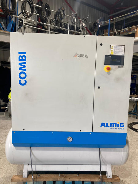 Large industrial machine with 'COMBI' and 'ALMIG' branding in a warehouse setting.