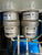 Two Almig compressed air filter elements, labeled Element DF 300 and Element AFM 300, installed side-by-side on a blue machine base.