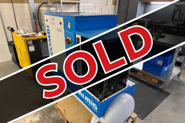 Almig air compressor on a pallet in an industrial setting