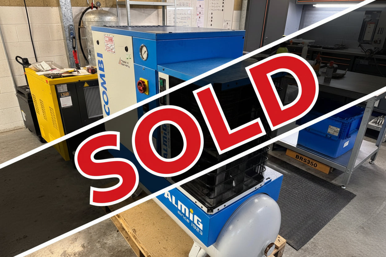 Almig air compressor on a pallet in an industrial setting