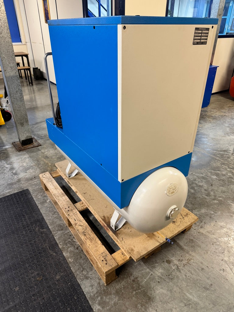 Blue and beige industrial machine on a wooden pallet in an indoor setting