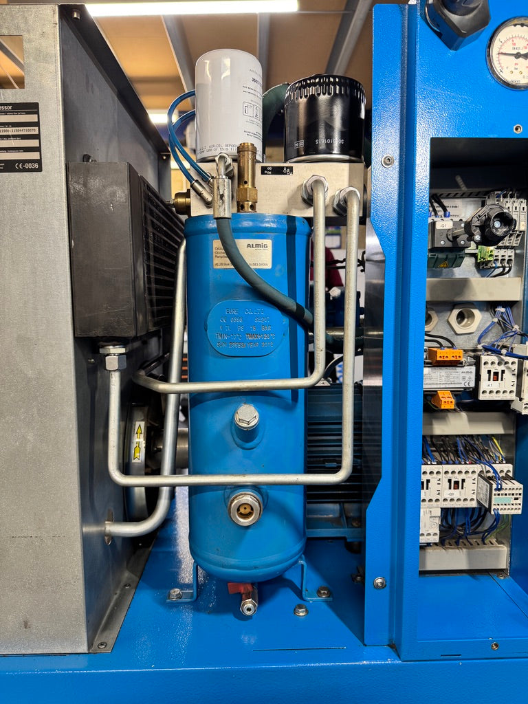Blue industrial compressor with visible branding in a mechanical setting