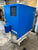 Blue industrial machine with 'Almig' branding on a concrete floor.