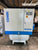 Compressor with 'Almig' and 'COWBI' branding in an industrial setting