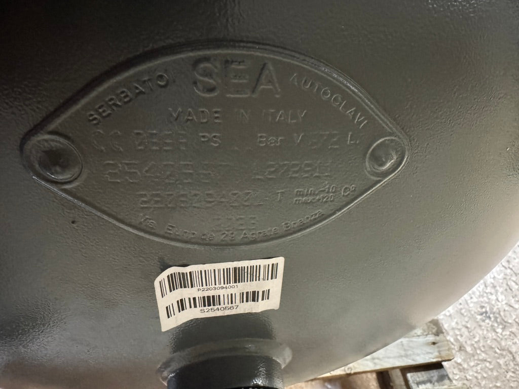 Metal component with 'SEA' branding and a barcode label on a blurred background