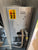Back panel of a machine with warning labels and hoses