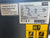 Atlas Copco air compressor label with technical specifications and branding.