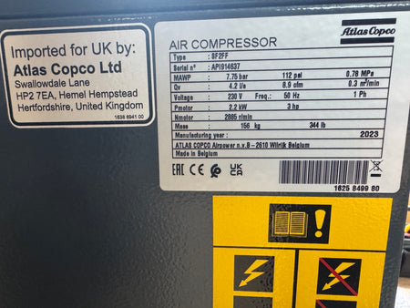 Atlas Copco air compressor label with technical specifications and branding.
