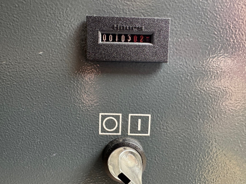 Vintage electronic device with a digital display and switch on a gray background