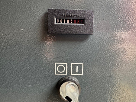 Vintage electronic device with a digital display and switch on a gray background