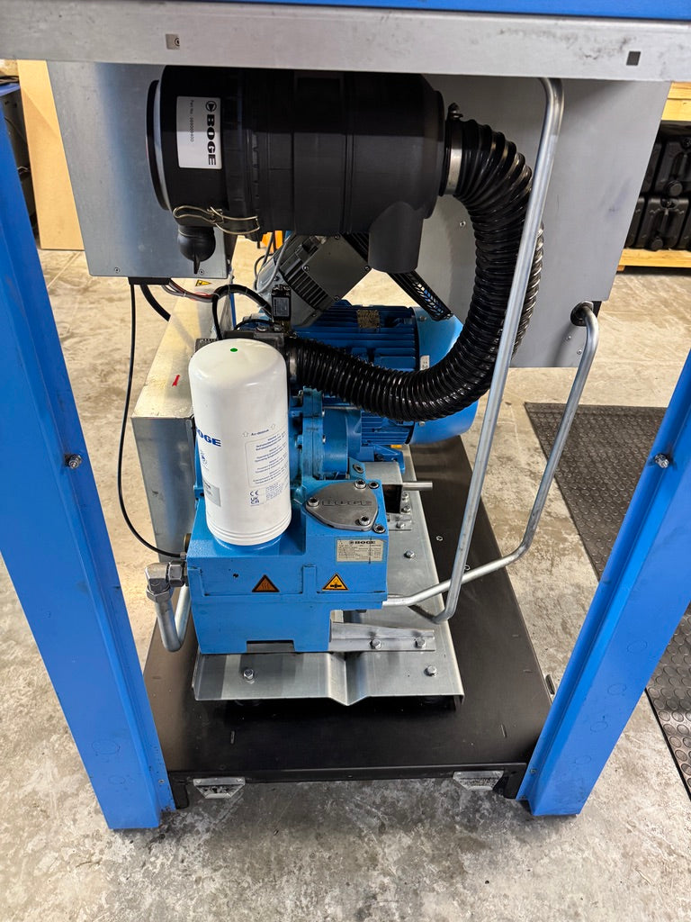 Industrial machine with blue frame and black components on a concrete floor.