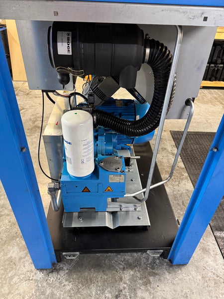 Industrial machine with blue frame and black components on a concrete floor.