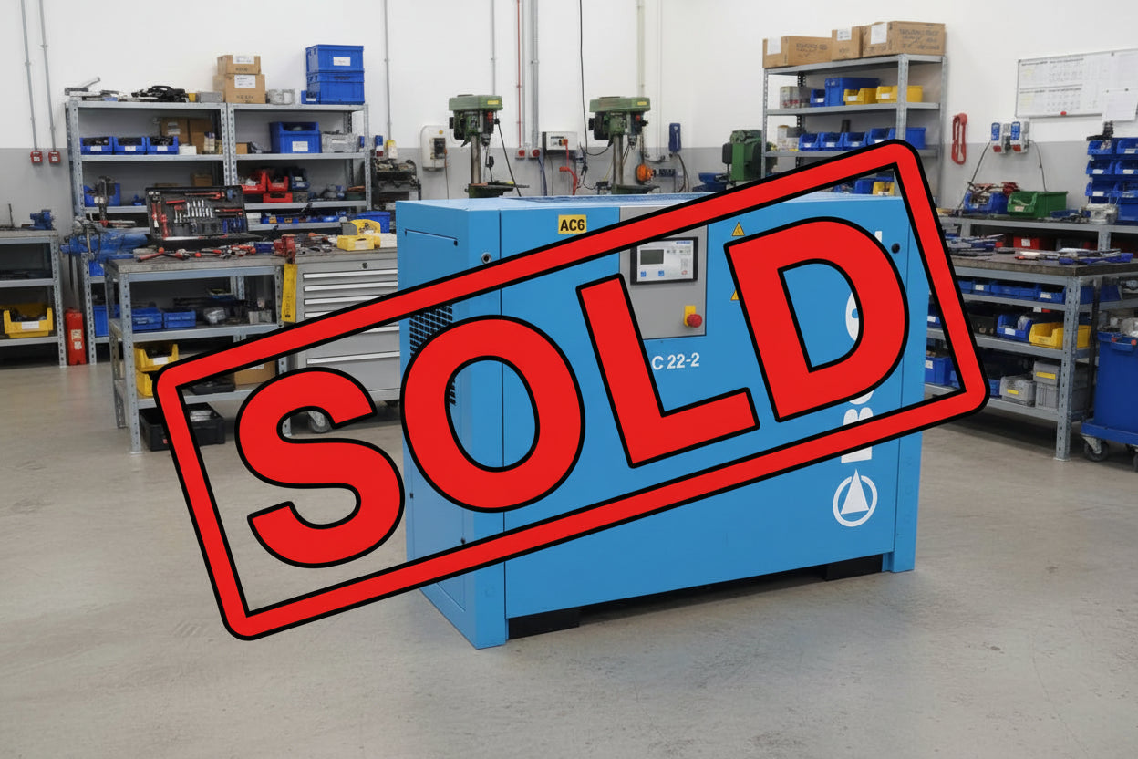 Blue Boge compressor on a concrete surface with a car and green container in the background