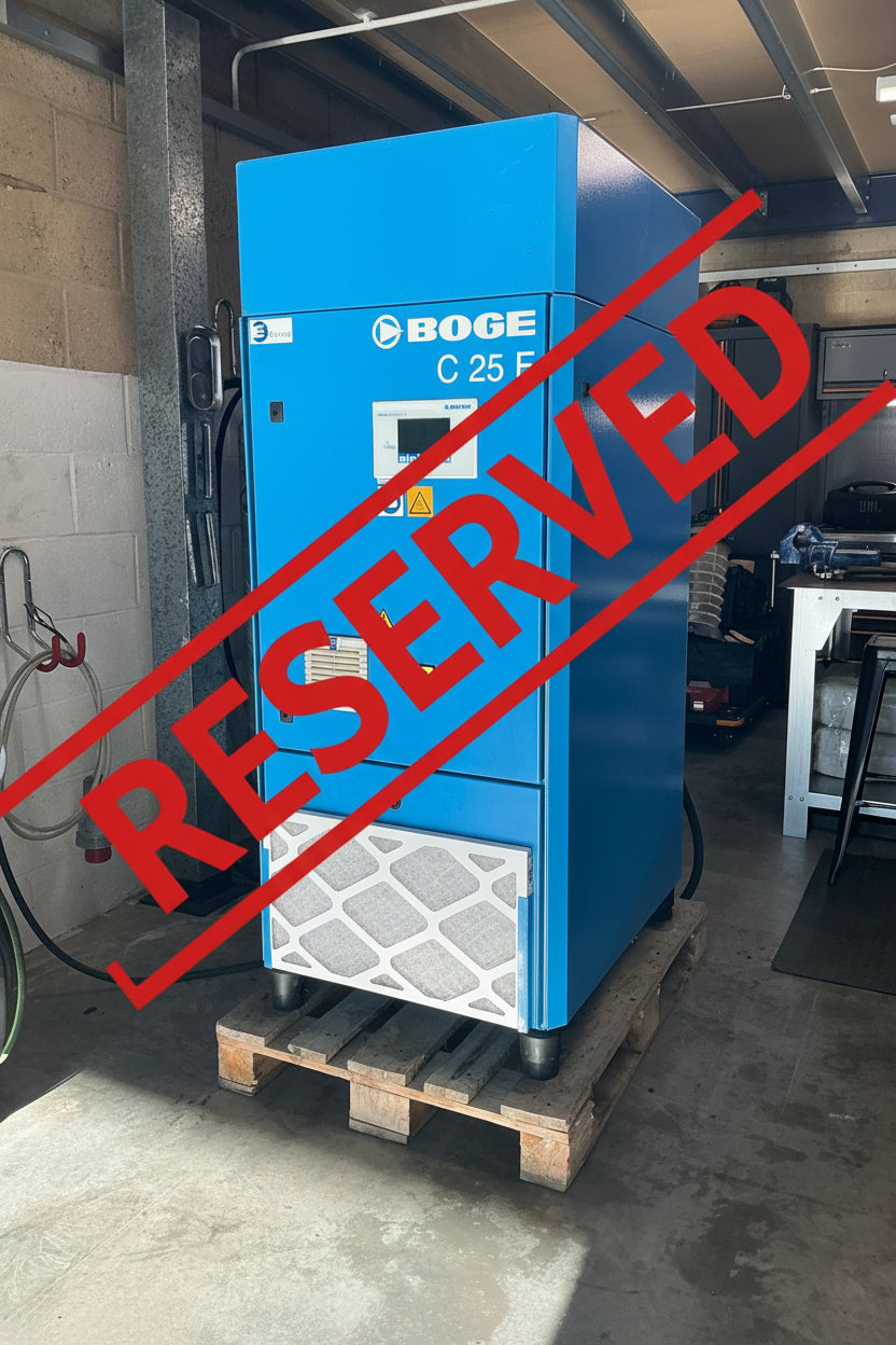 A blue BOGE C 25 F industrial air compressor sitting on a wooden pallet in a workshop environment.