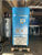 A blue BOGE C 25 F air compressor unit with an attached gray air tank, photographed in a workshop or industrial setting.