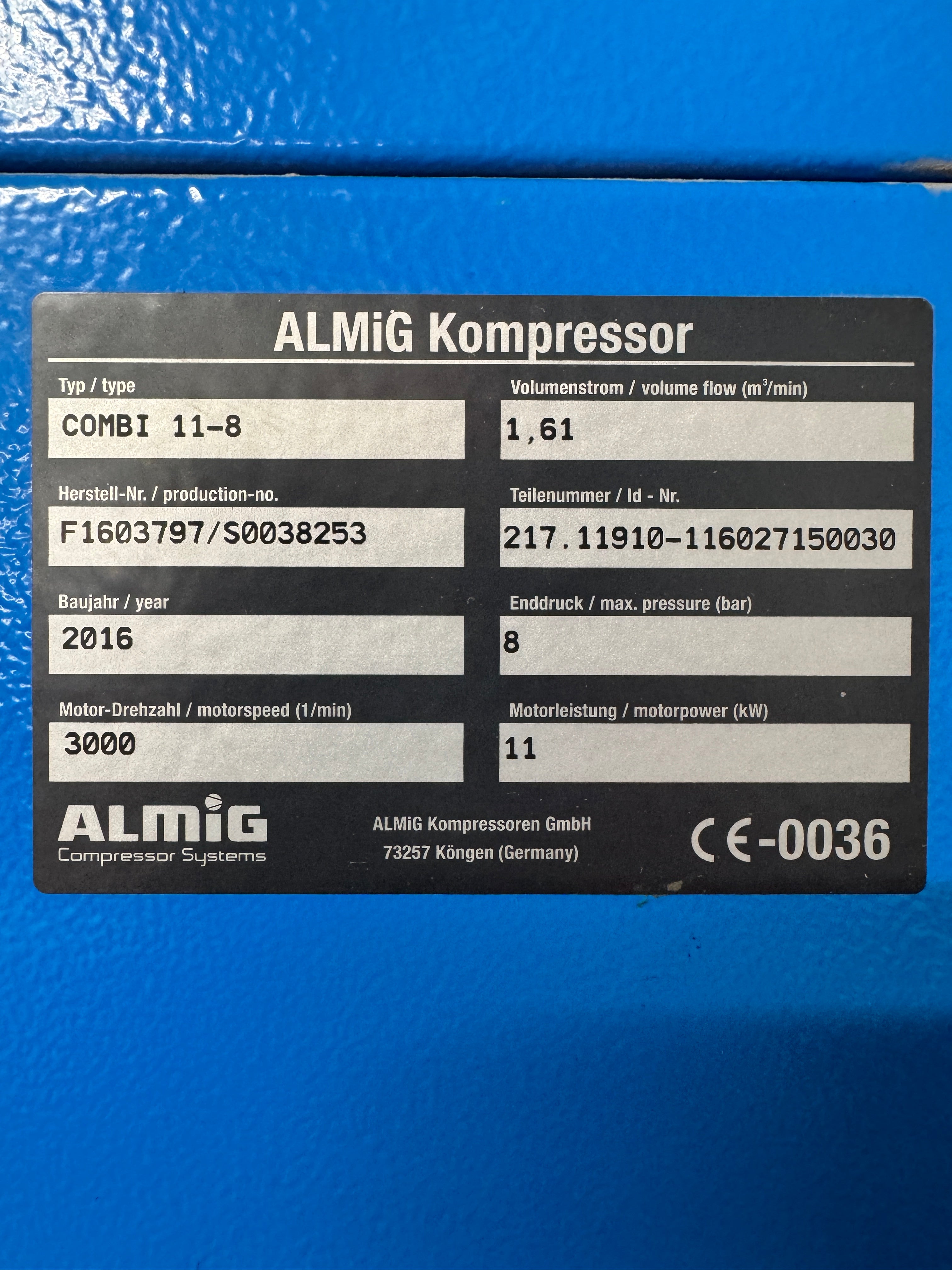 Black label with text and ALMIG logo on a blue background