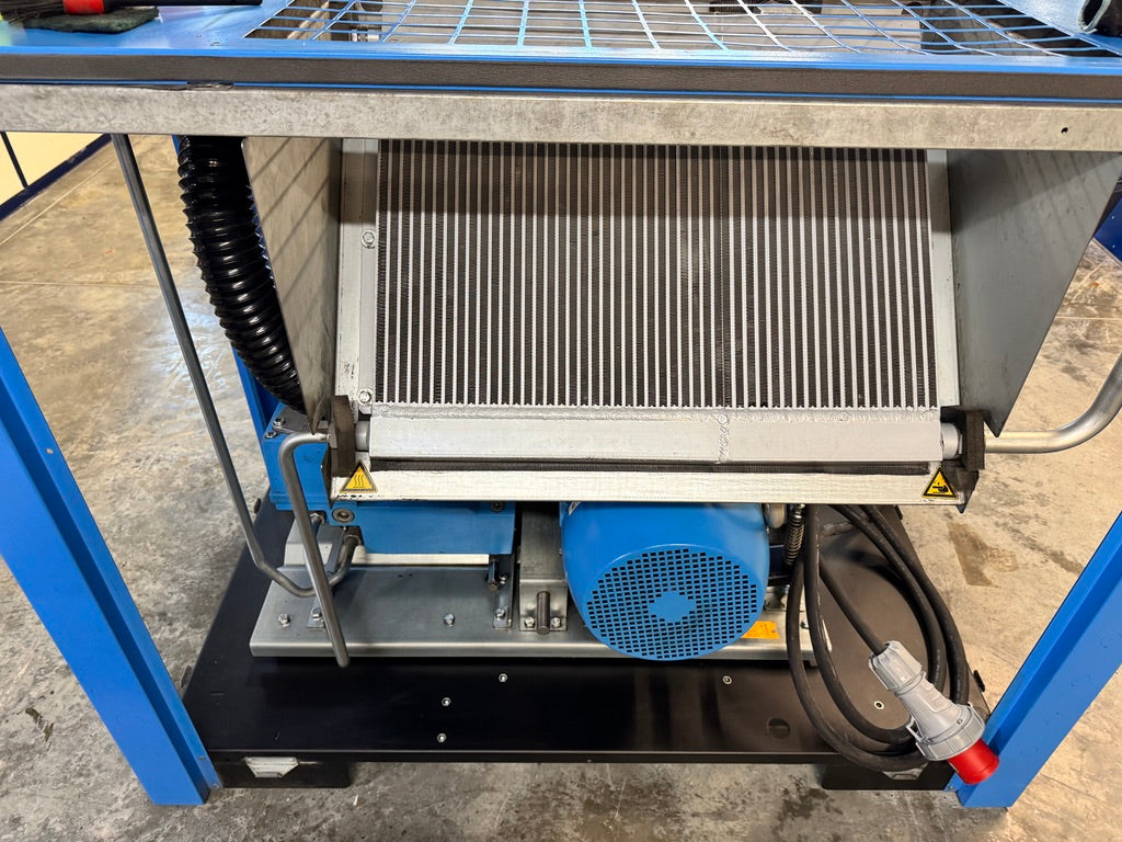 Mechanical cooling system with a fan and heat exchanger on a concrete floor.