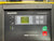 Kaeser Sigma Control Basic industrial touchscreen control panel with a gray faceplate, green and red buttons, and a small display screen.