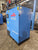 Blue compressor with 'AR' and 'Norton' branding in a warehouse setting