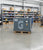Atlas Copco industrial compressor on a pallet in a warehouse setting