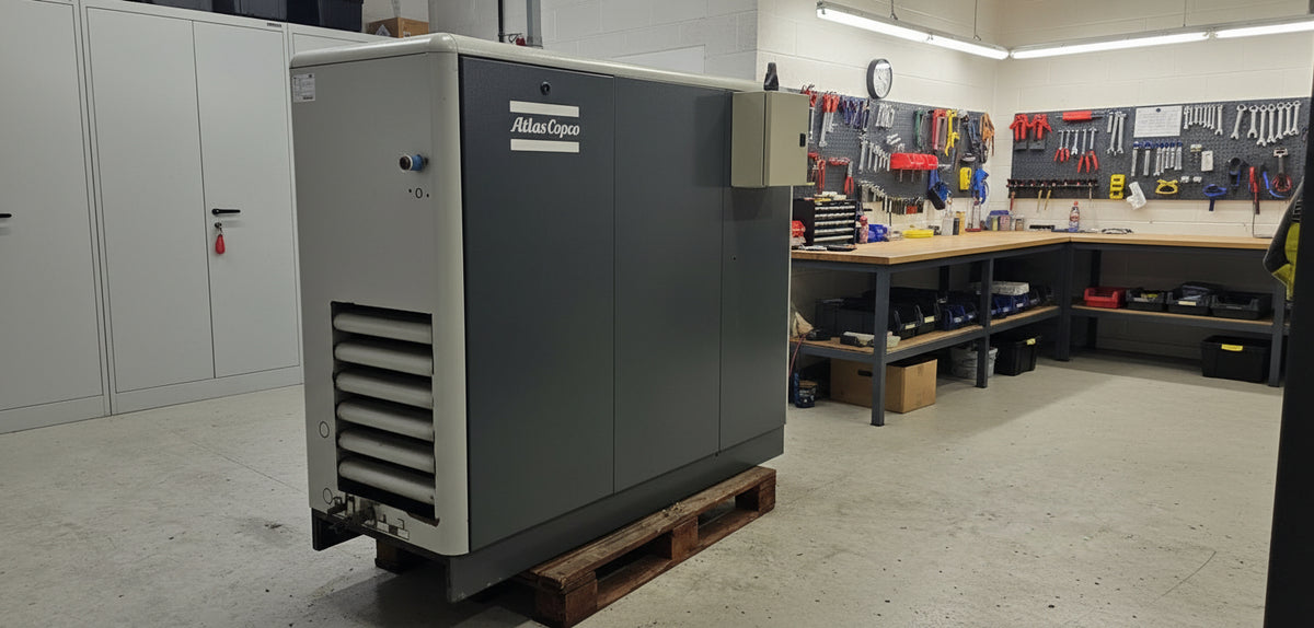 Large industrial air compressor with Allen-Bradley branding in a warehouse setting.