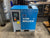 A blue and gray MSA Filtrary Mark industrial air compressor unit with a digital control panel, photographed in a workshop environment.