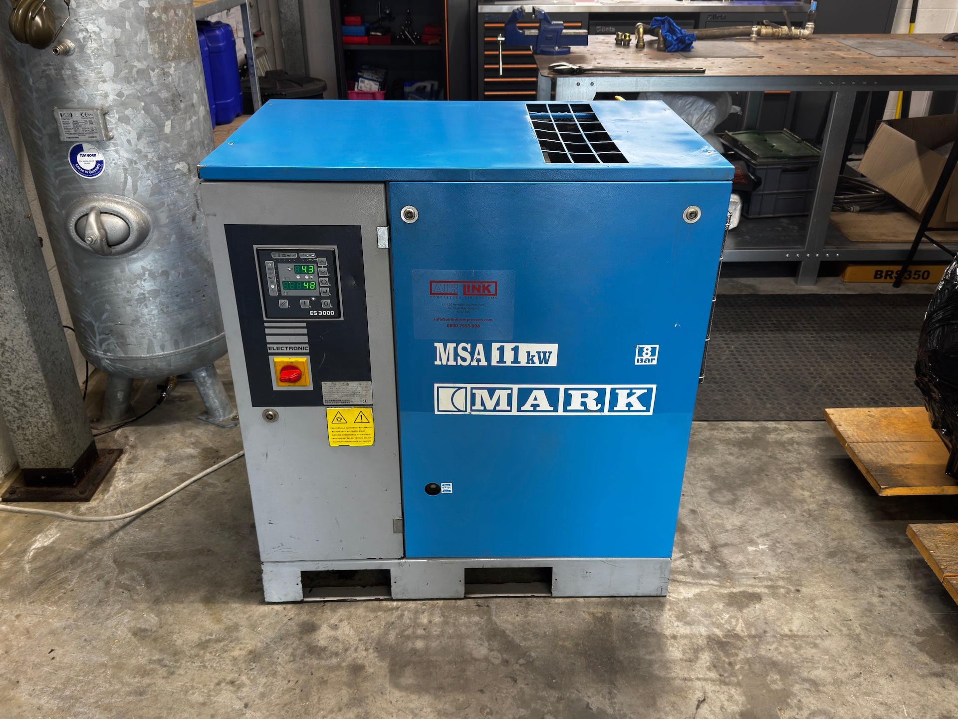 A blue and gray MSA Filtrary Mark industrial air compressor unit with a digital control panel, photographed in a workshop environment.