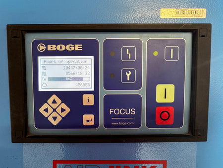 A BOGE industrial control panel with a dark frame, featuring a blue and purple faceplate, a small digital display screen, and multiple physical buttons including yellow and red buttons on a blue painted metal surface.