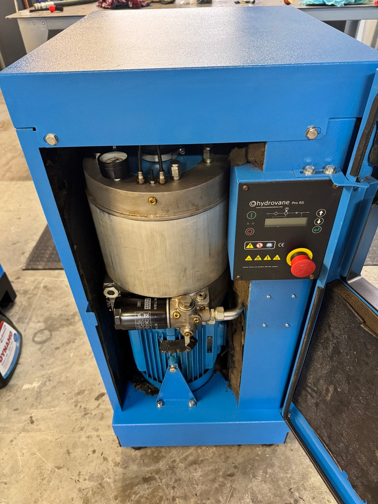 Blue industrial machine with a metallic component on a concrete floor