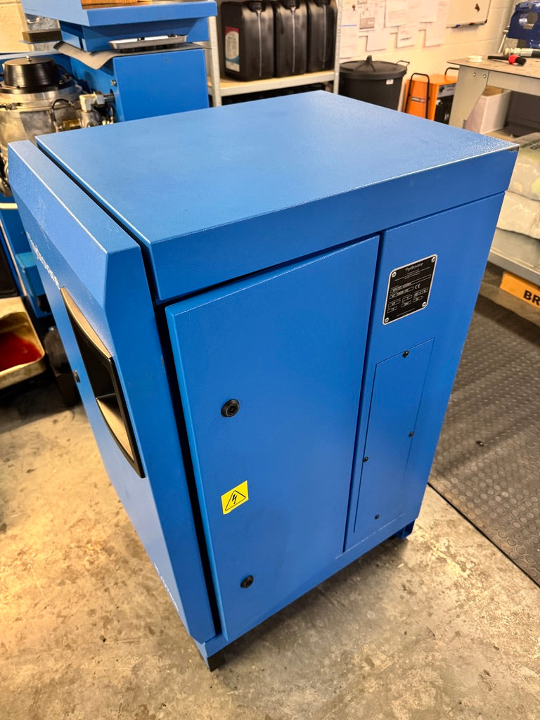 Blue industrial cabinet with a warning label on a workshop floor