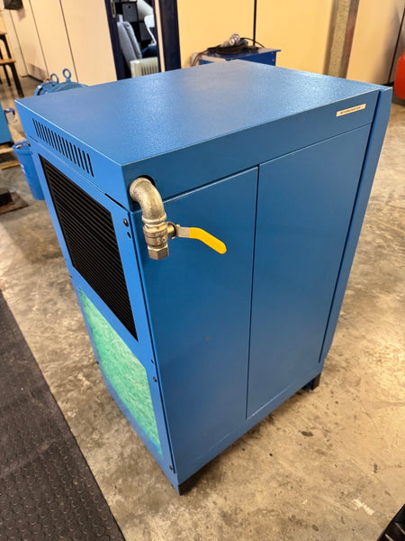 Blue industrial machine with a yellow valve on a concrete floor