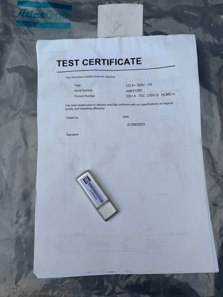 Test certificate and USB drive on a reflective surface