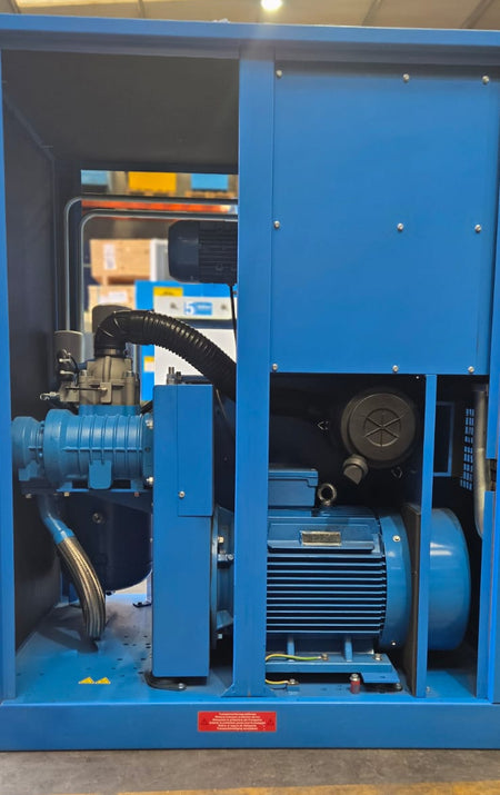 Blue industrial machine or compressor in a warehouse setting
