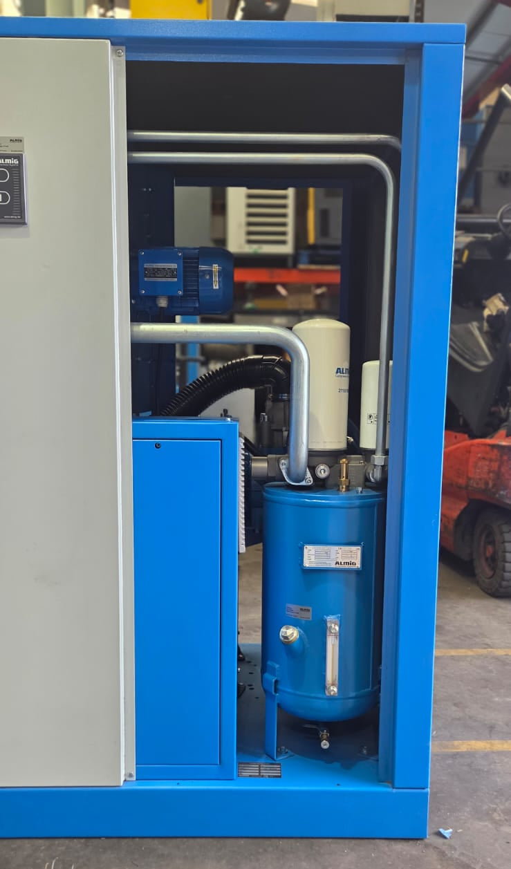 Blue industrial cabinet with various components inside, on a concrete floor.
