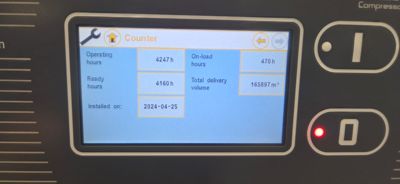 Display screen of a machine showing operational hours and other metrics.