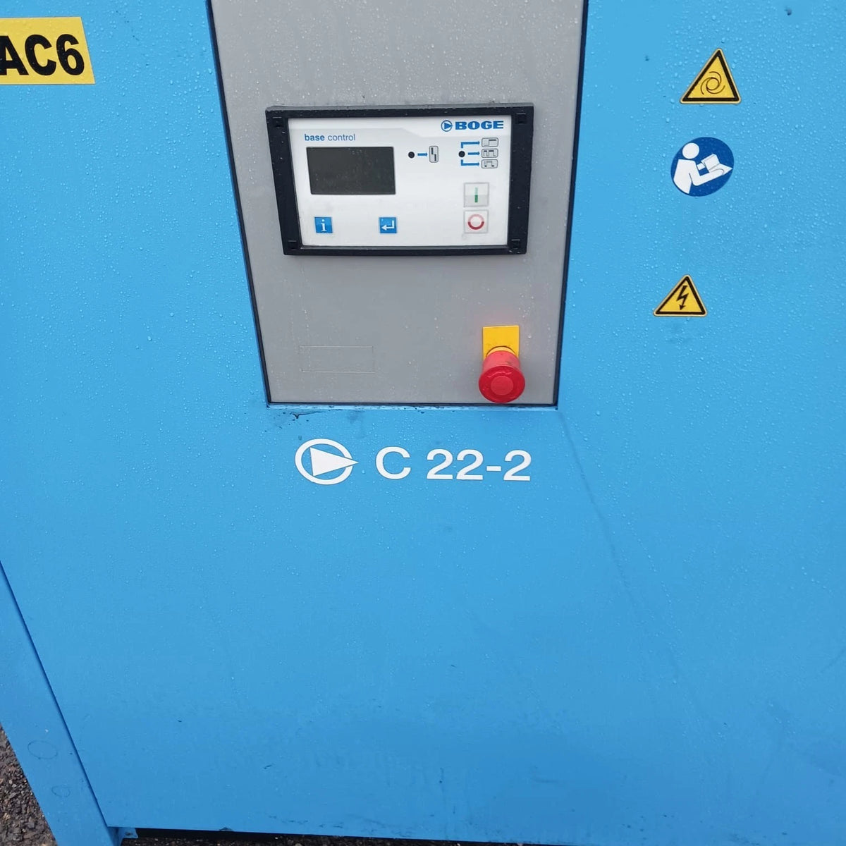 Blue industrial machine with control panel and warning symbols