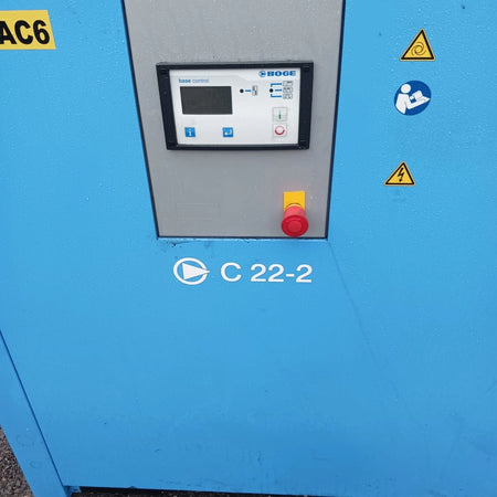 Blue industrial machine with control panel and warning symbols